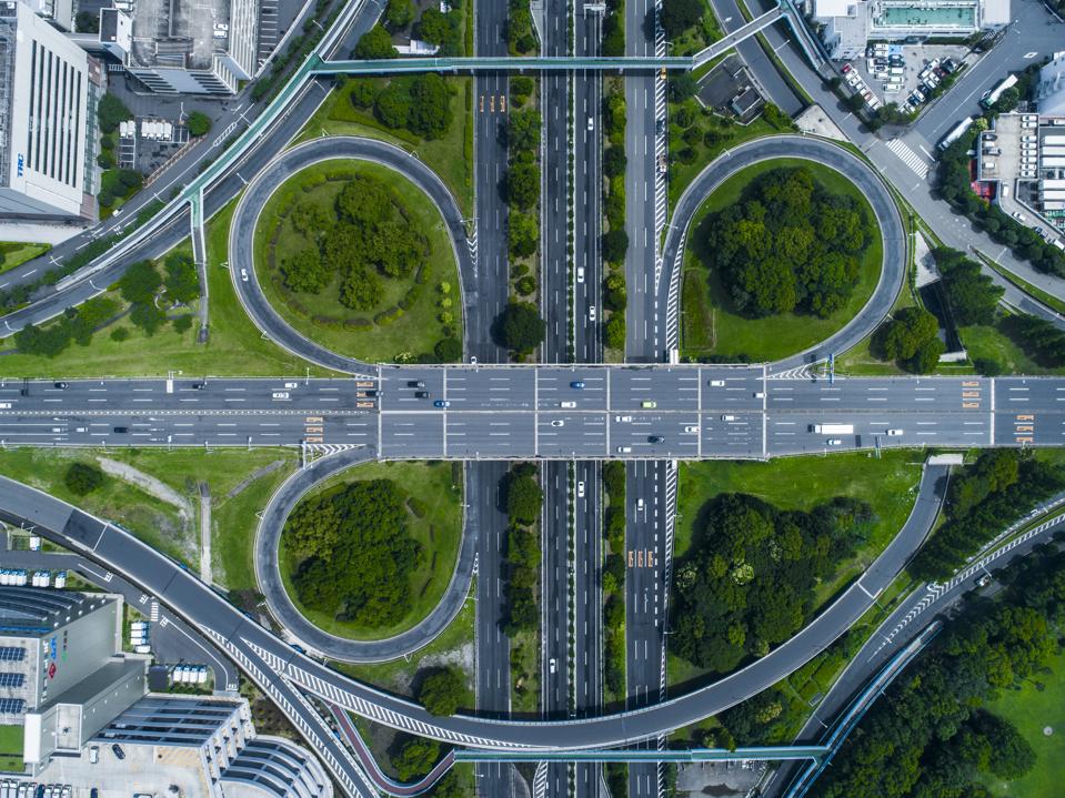 A crossing highway. Scenery of the town with trees.