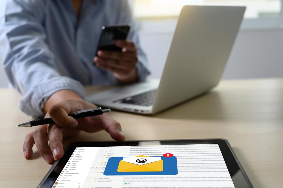 Midsection Of Businessman Using Technologies At Desk In Office