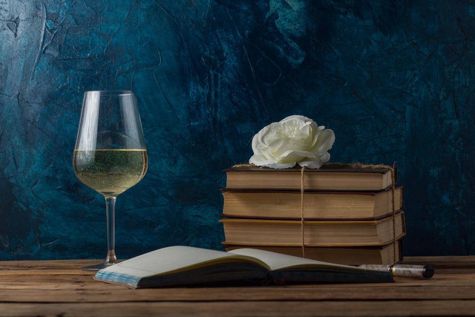 Glass with White Wine, Books Connected by a Juggle Rope, White Rosebud, An Open Book and Pen