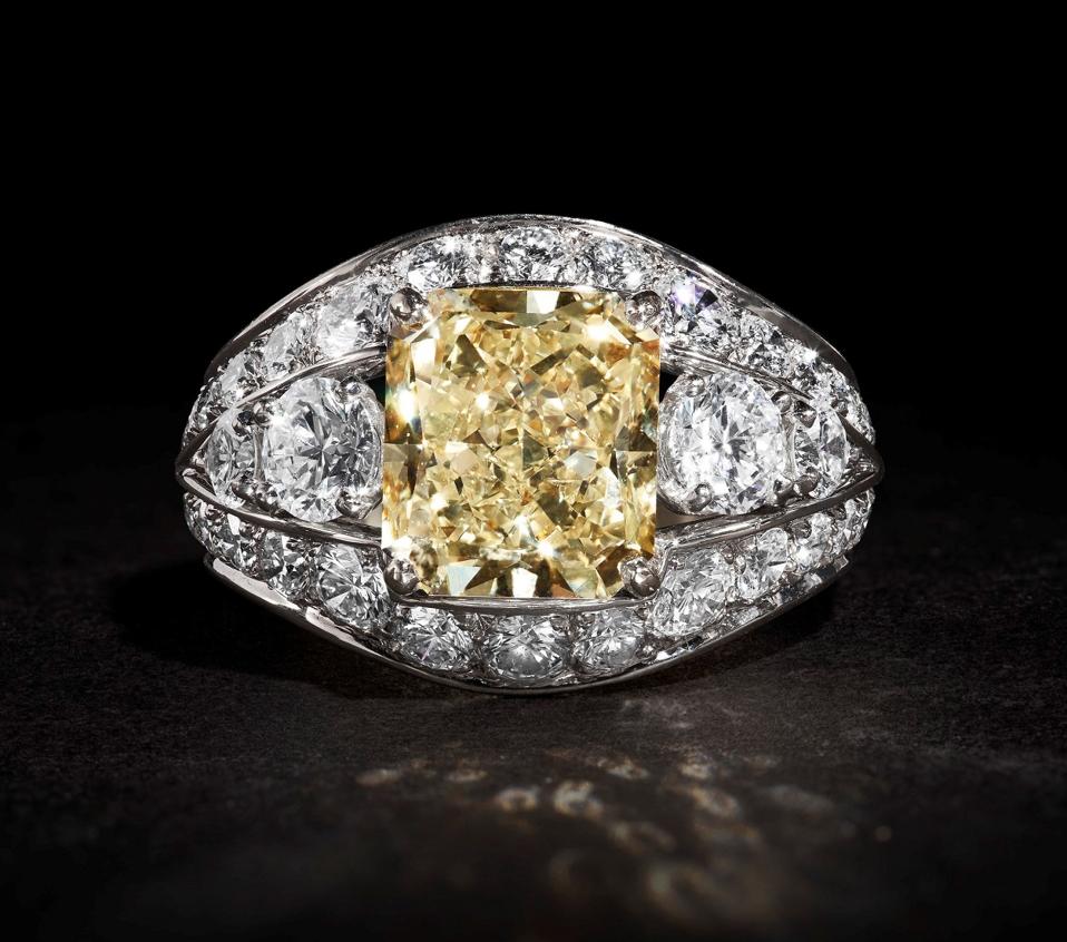 A Graff 18k white and yellow gold ring centered with a 5.18-carat fancy yellow diamond