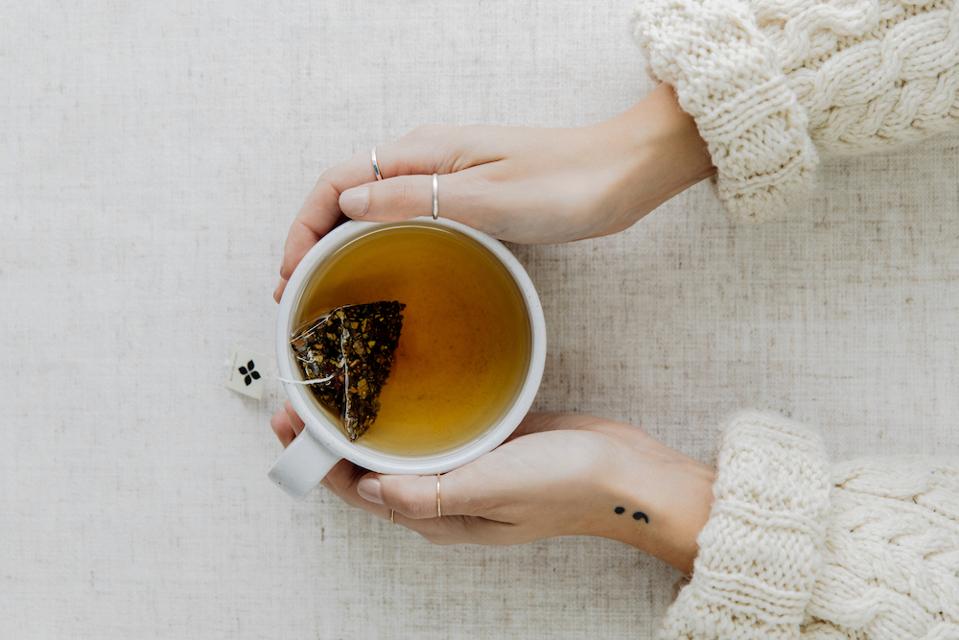 A cup of tea made with an Art of Tea teabag sachet.