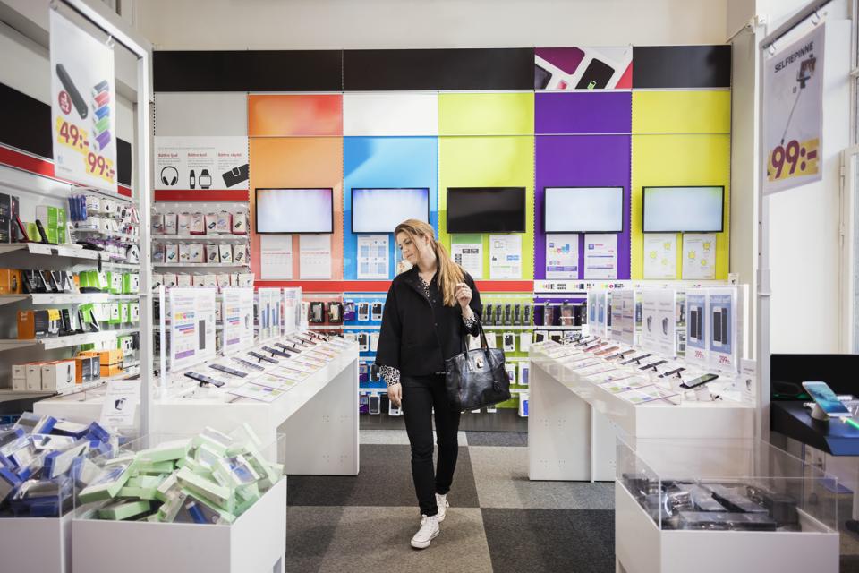 Female customer viewing smart phones in store