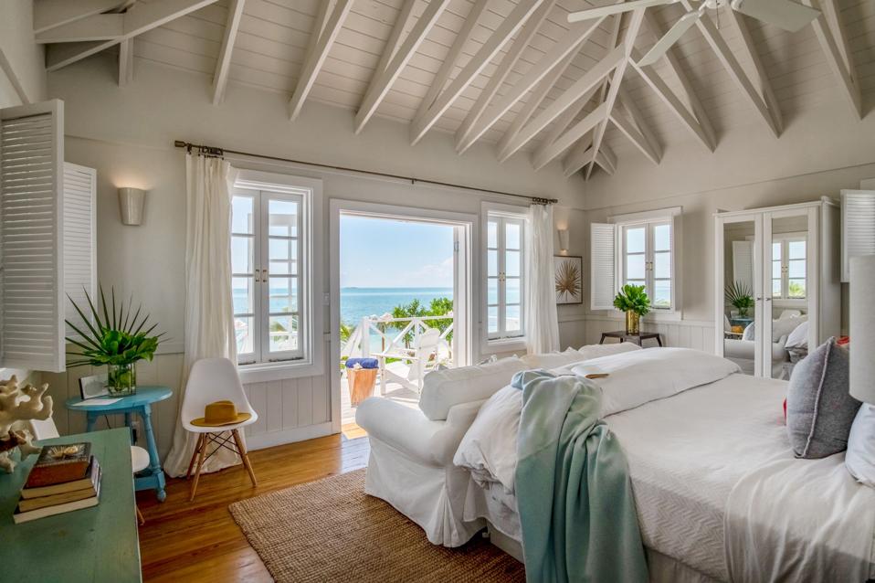 A whitewashed interior of a cottage overlooking the water
