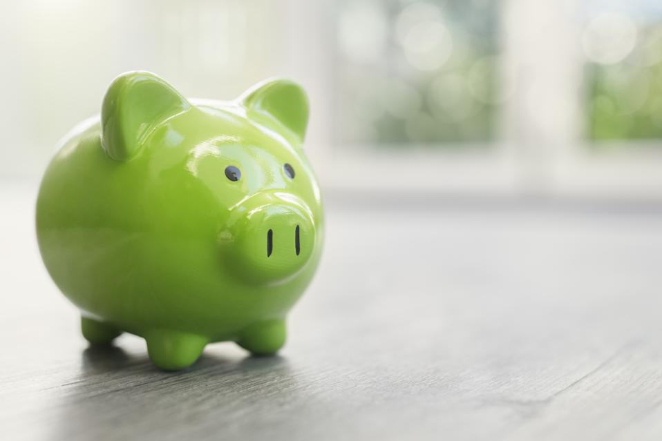 Piggy bank on home floor real estate investment concept