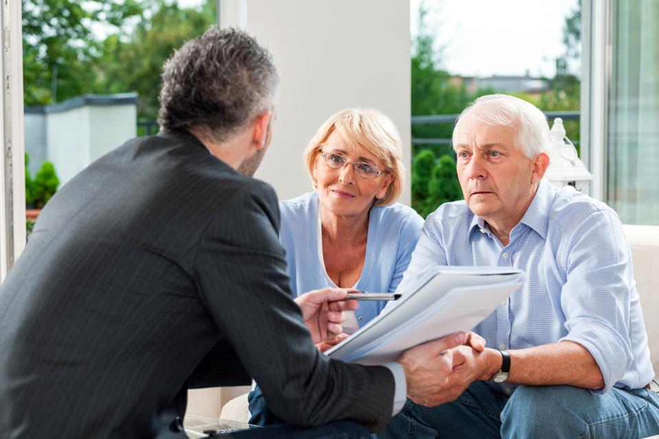 Senior couple talking with financial advisor