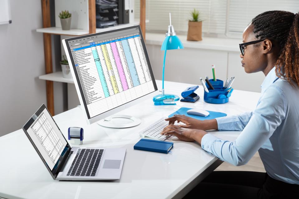 Businesswoman Analyzing Data On Computer