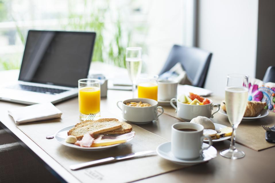 Breakfast on table beside laptop computer