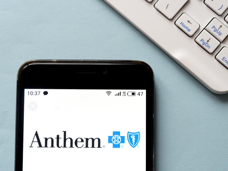 In this photo illustration an Anthem logo seen displayed on...
