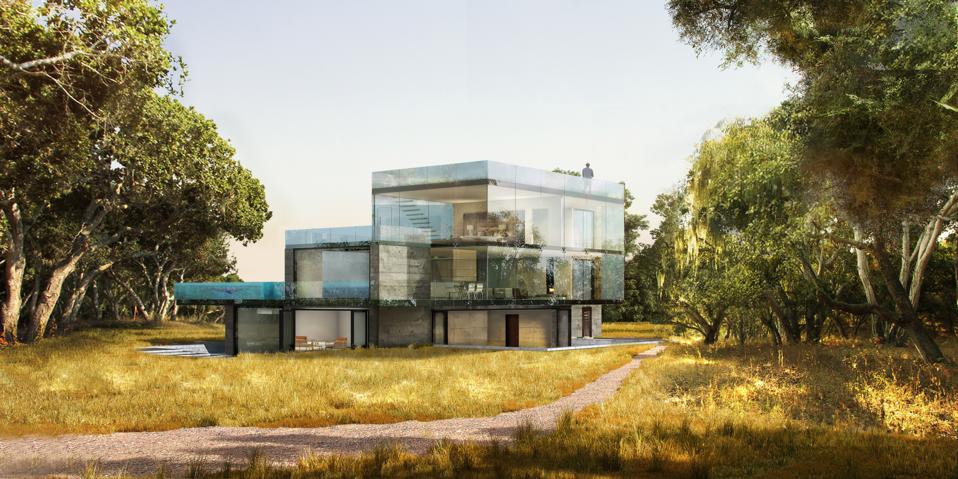 A glass-enclosed concept home surrounded by trees.