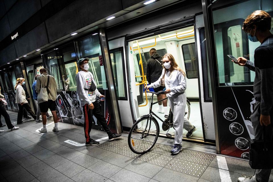 People wearing face masks at a metro station in Copenhagen, Denmark.