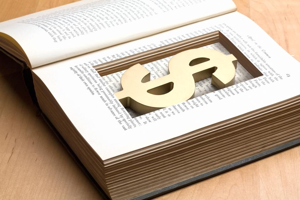 dollar symbol in cutout inside book