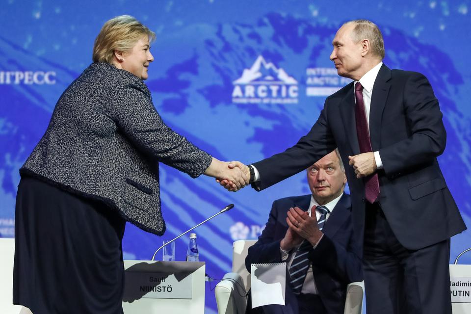 APRIL 9, 2019: Norway's Prime Minister Erna Solberg and Russia's President Vladimir Putin (L-R front) speak at session titled ″The Arctic: An Ocean of Opportunity″