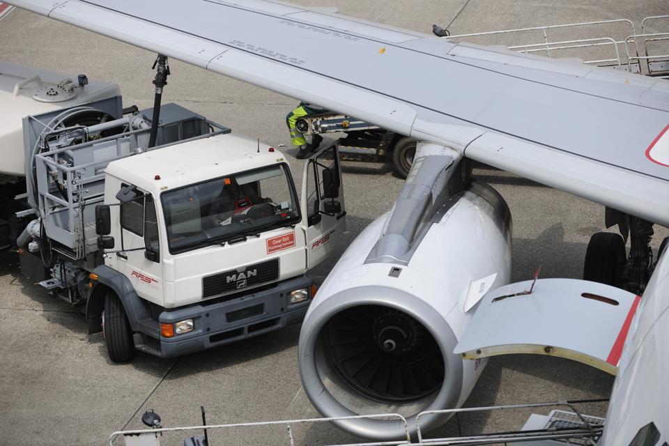 refuelling bowser with hose attached under the wing of an Air Berlin Airbus A319 parked