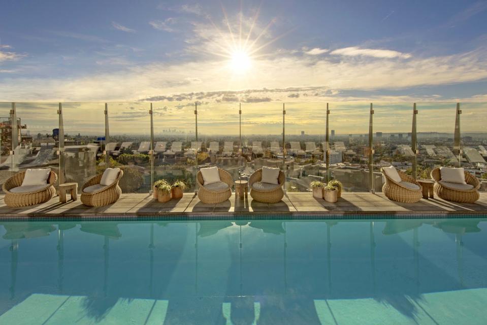 The pool deck at 1 Hotel West Hollywood in Los Angeles. More visitors are taking ″microlocal″ vacations within walking distance to their hotel.