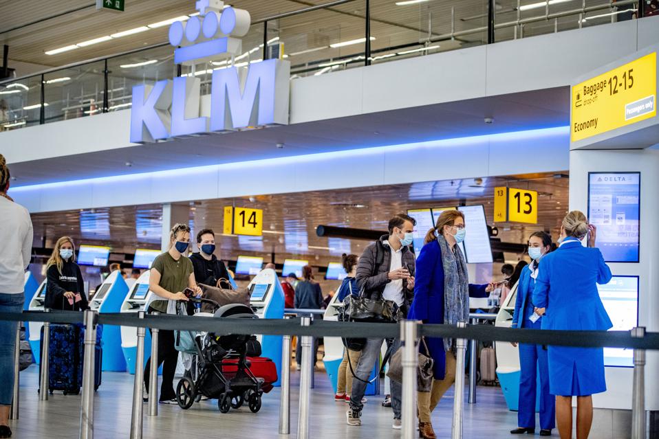 Travelers with face masks at the Schiphol airport in the Netherlands Europe during Covid