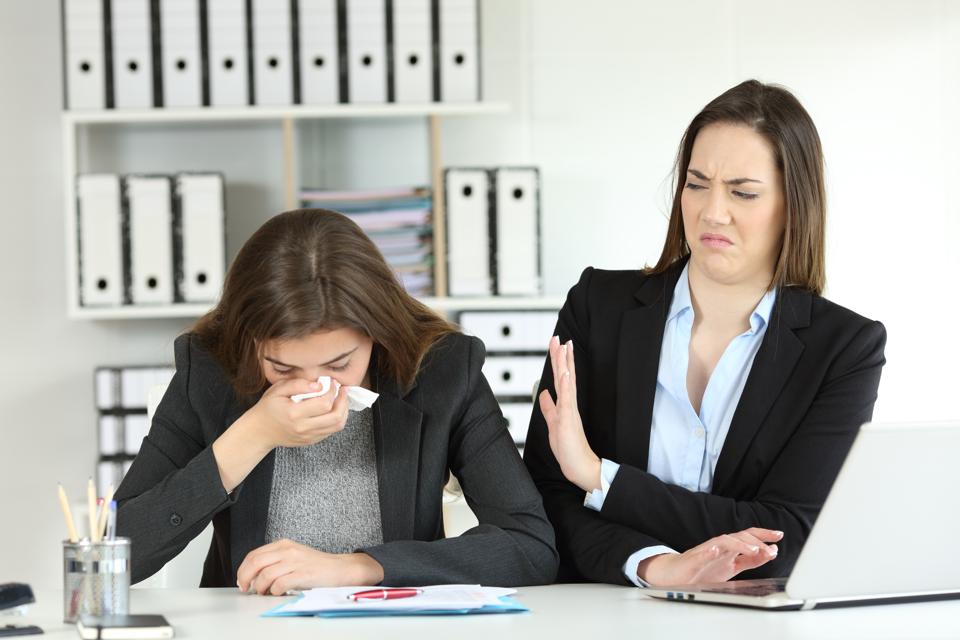 Ill businesswoman and a colleague rejecting her