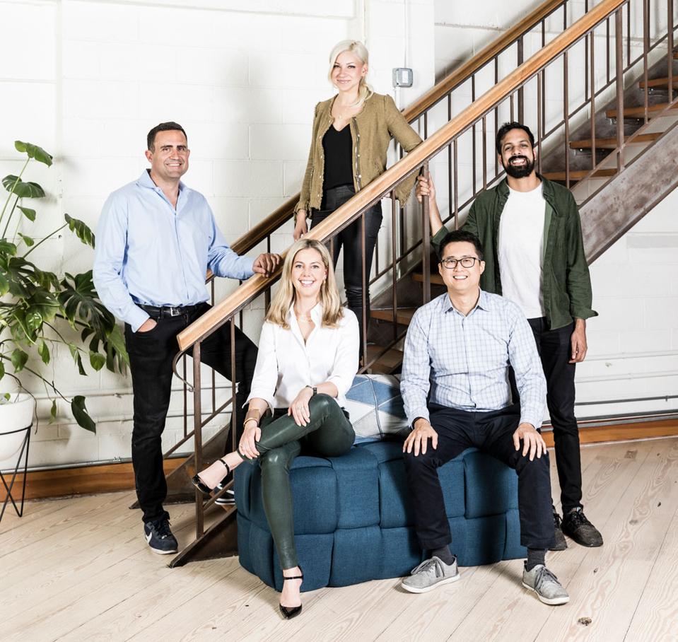Group of professionally-dressed employees gathered together.