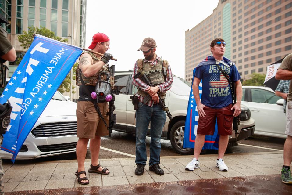 A group of men carry AR-15 style rifles during the We Will...
