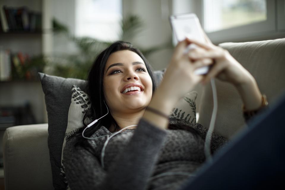 Young woman enjoying music at home
