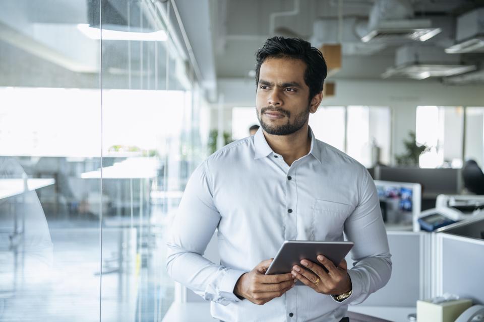 Businessman in modern office with tablet