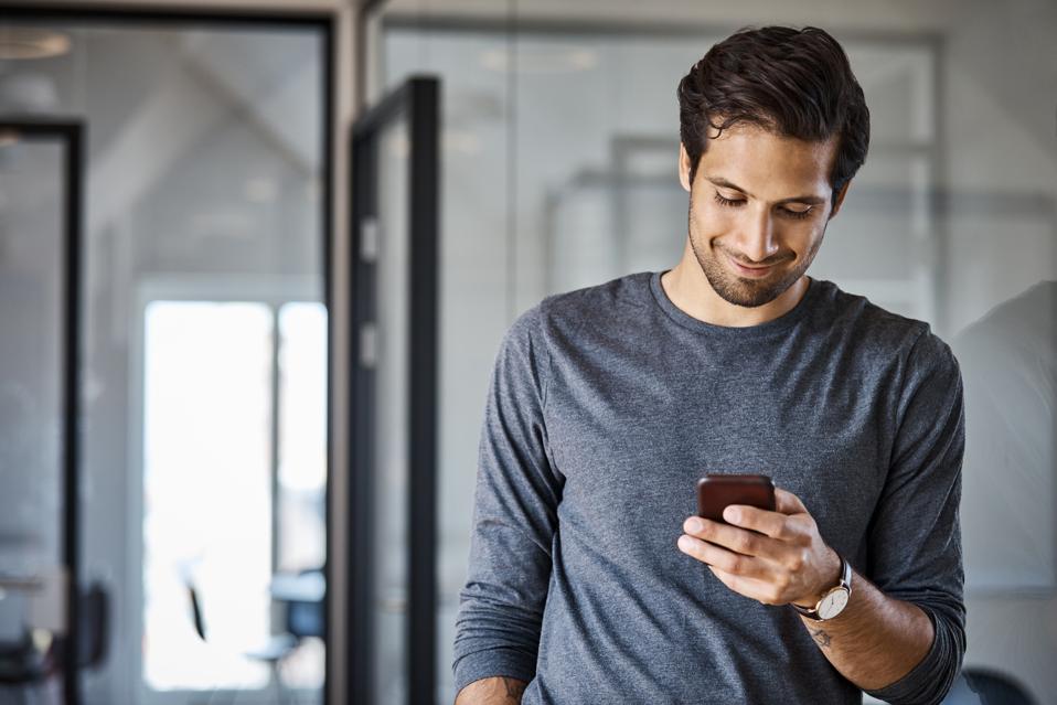 Professional using mobile phone at office