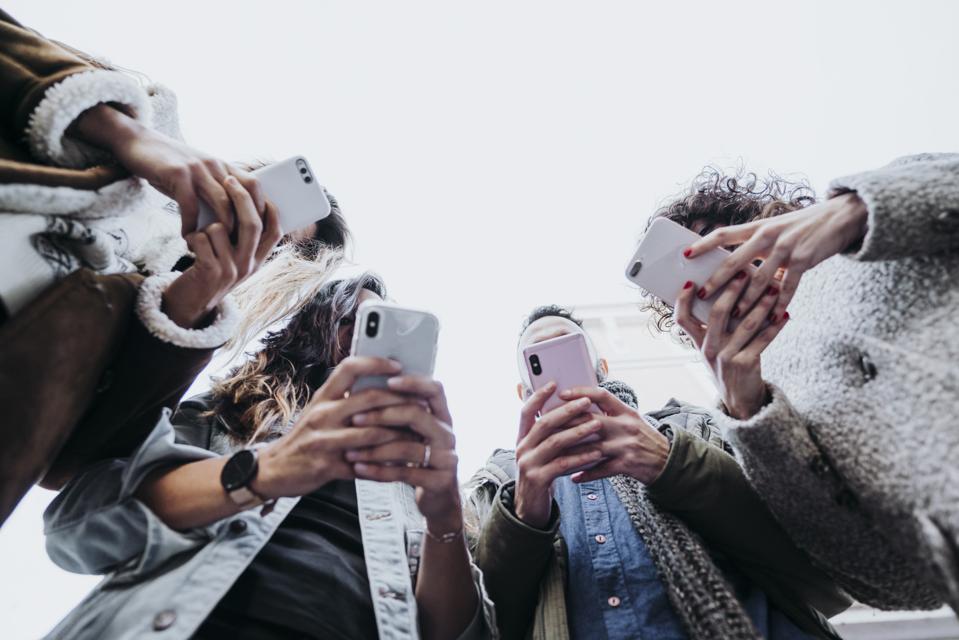 Group of friends in the street with smartphone