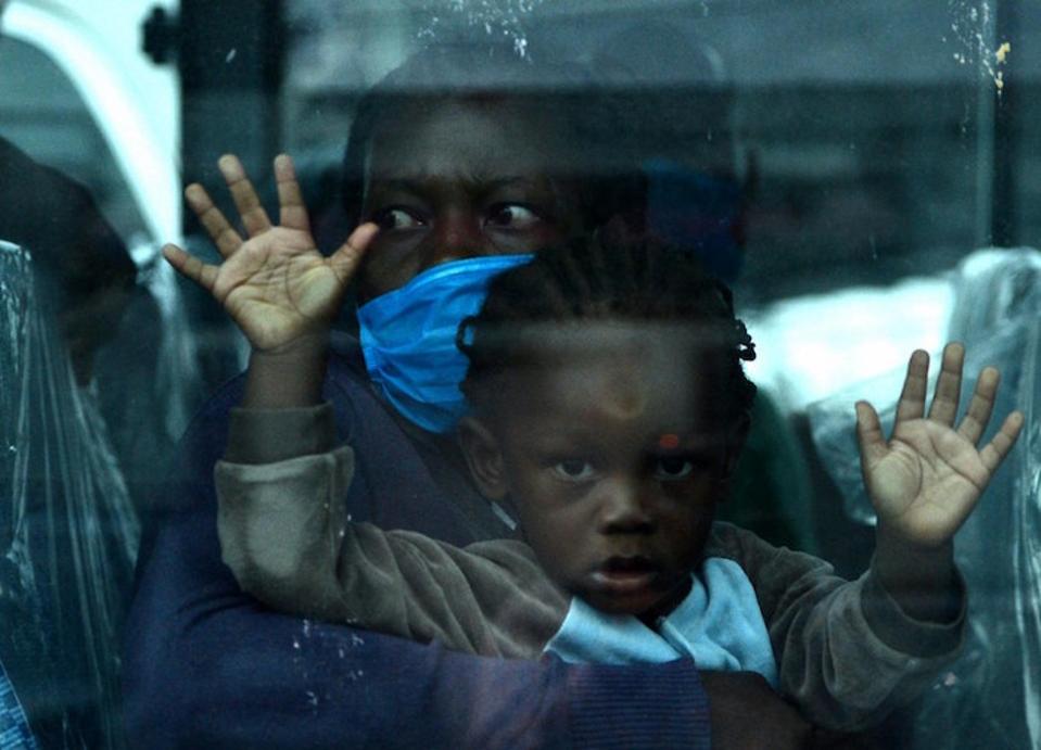 A mother and her child photographed in Honduras on June 3, 2020, aboard a bus headed for Toncontin international airport, where they will be tested for COVID-19 and then quarantined for two weeks in nearby Tegucigalpa.