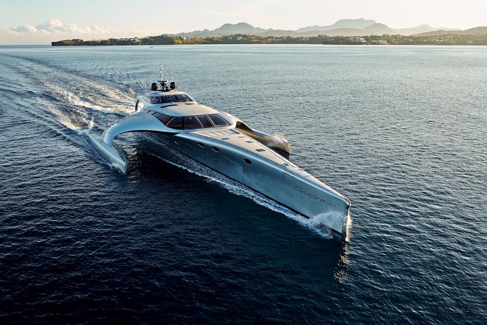 The front of the ADASTRA trimaran yacht as she sails on the ocean.