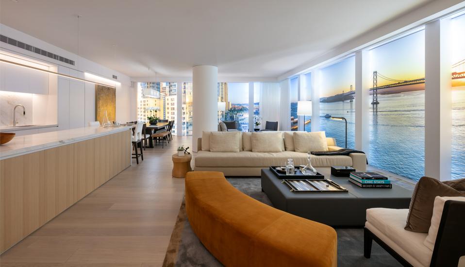 A sleek residential unit with floor-to-ceiling windows overlooking the San Francisco Bay.