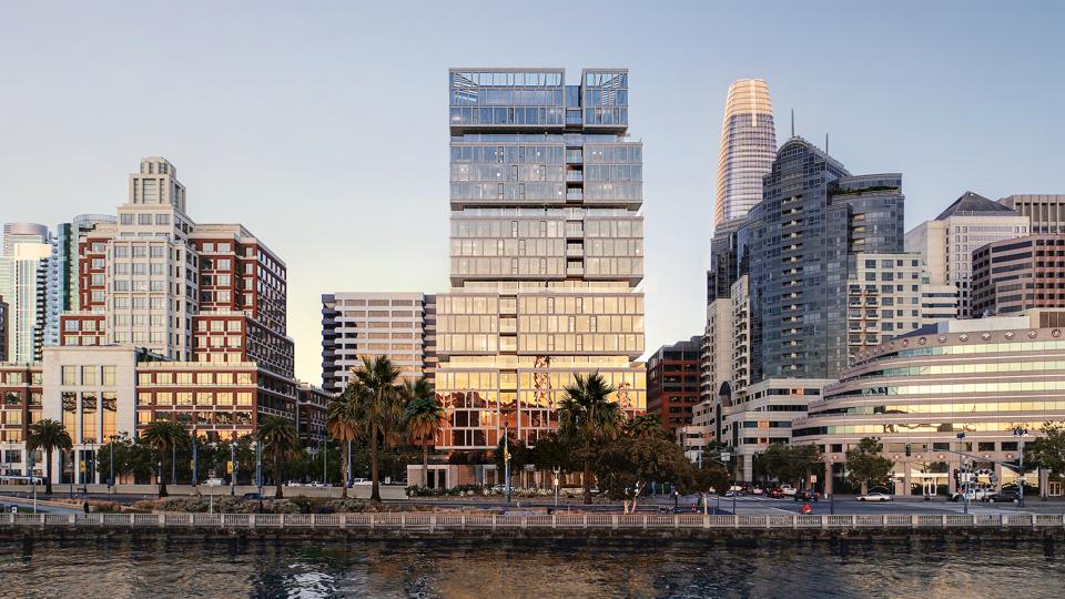 A sleek glass-and-stone building along the waterfront in San Francisco.