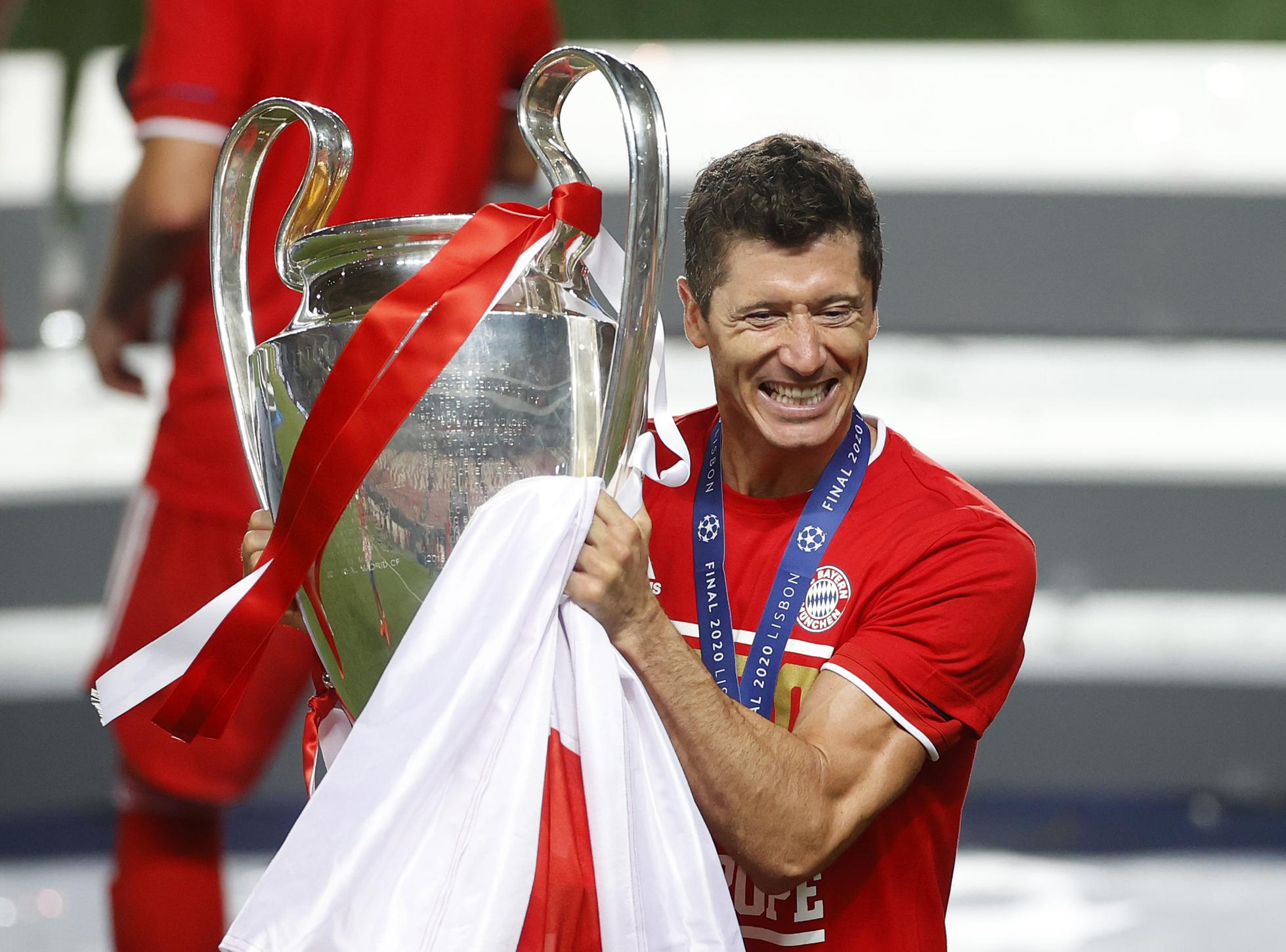 Robert Lewandowski of FC Bayern Munich with the UEFA Champions League Trophy following his team's victory over Paris Saint-Germain.