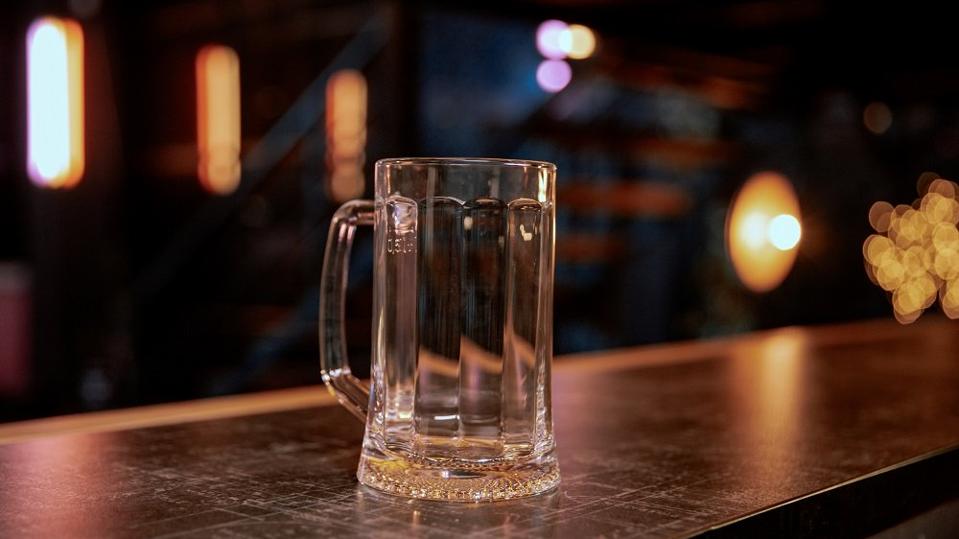 Empty pint lager on wooden table