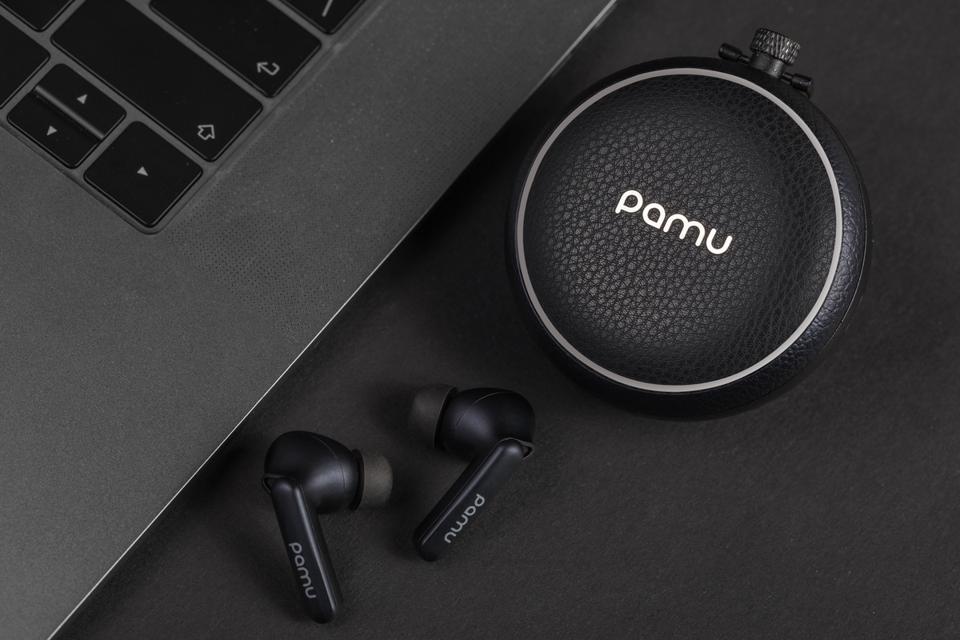 View of charging case and PaMu Quiet earphones next to a laptop