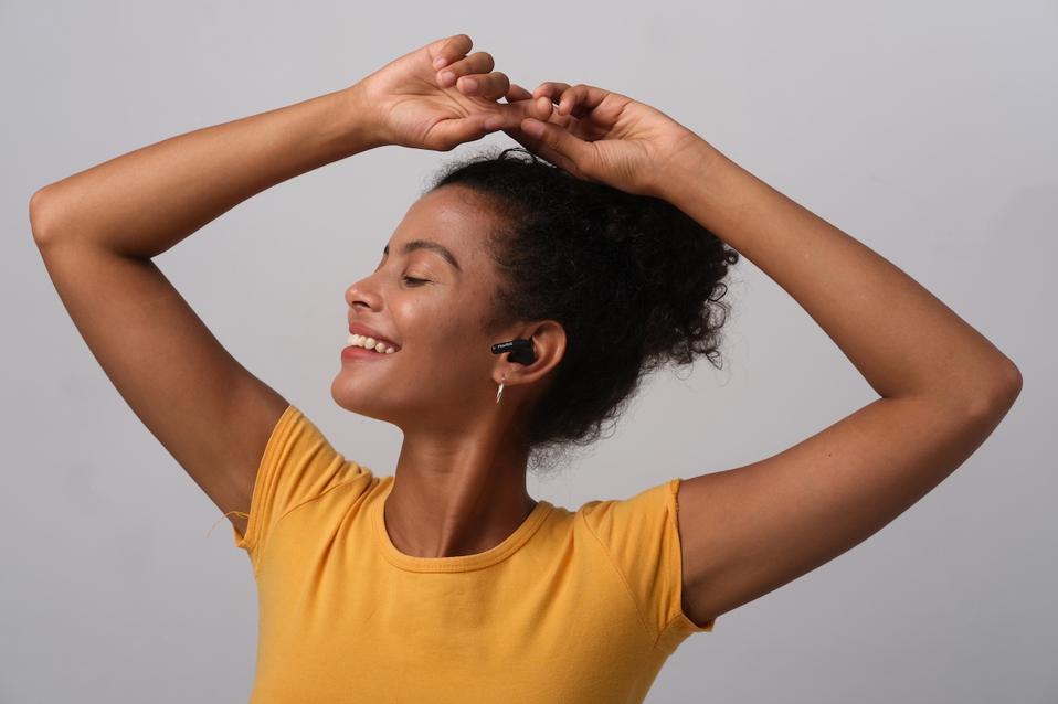 Woman listening to PaMu Quiet earphones