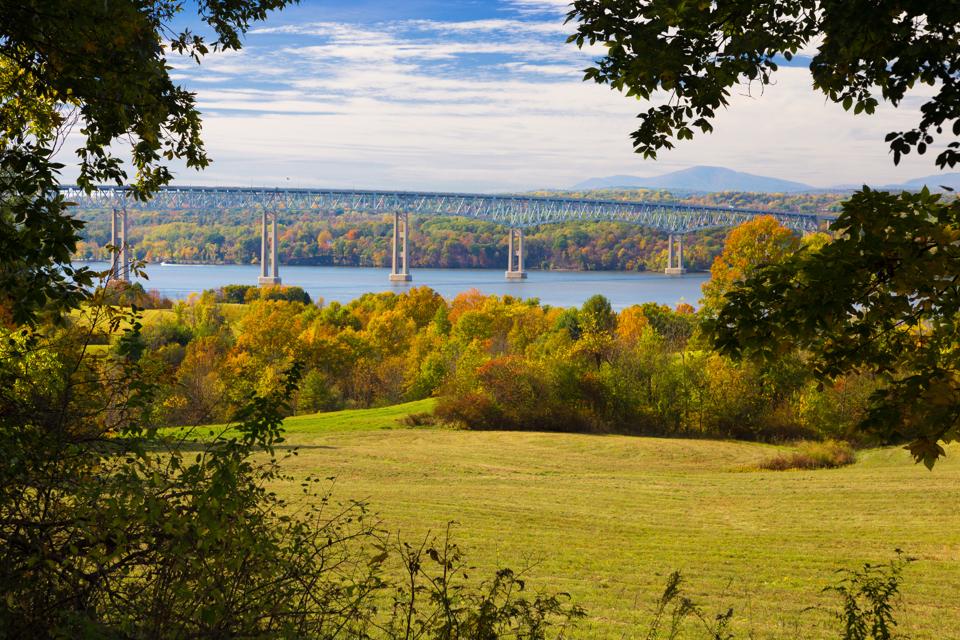 Kingston–Rhinecliff Bridge over Hudson River, Trees in Fall Colors (Foliage) and Blue Sky as seen from Poets' Walk, Red Hook, Hudson Valley, New York.