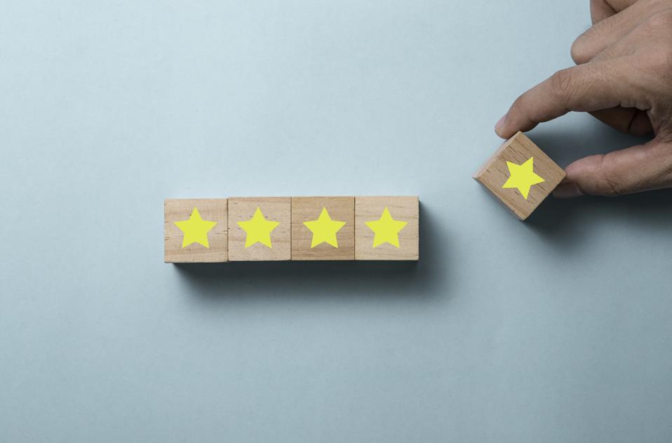 Hand putting five yellow stars