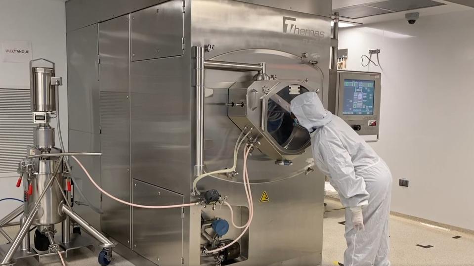 Worker checks on the progress of baricitinib manufacturing process.