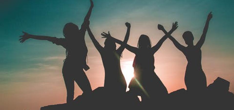 women celebrating on a mountain top