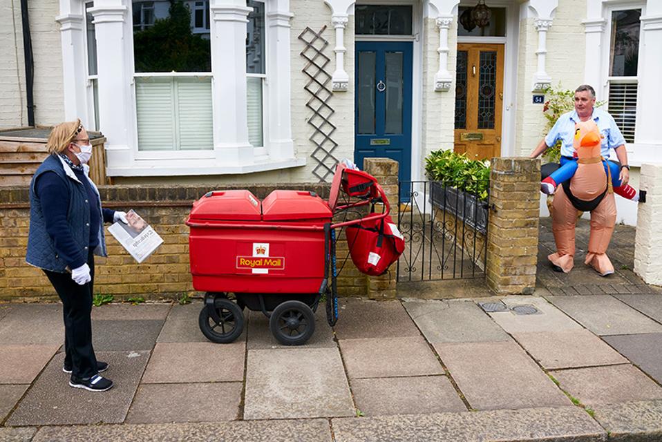Hold Still: A postman doing his round in fancy dress.