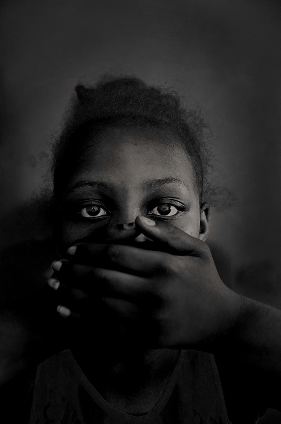 Hold Still portraits exhibit, black girl with hands covering mouth
