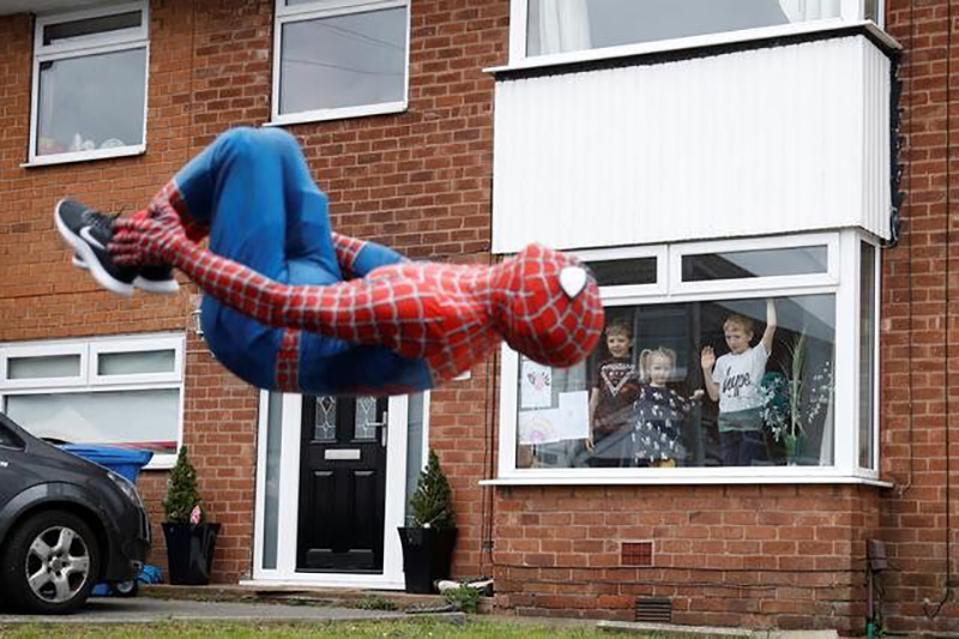 Hold Still photo exhibit, a Spiderman entertaining kids