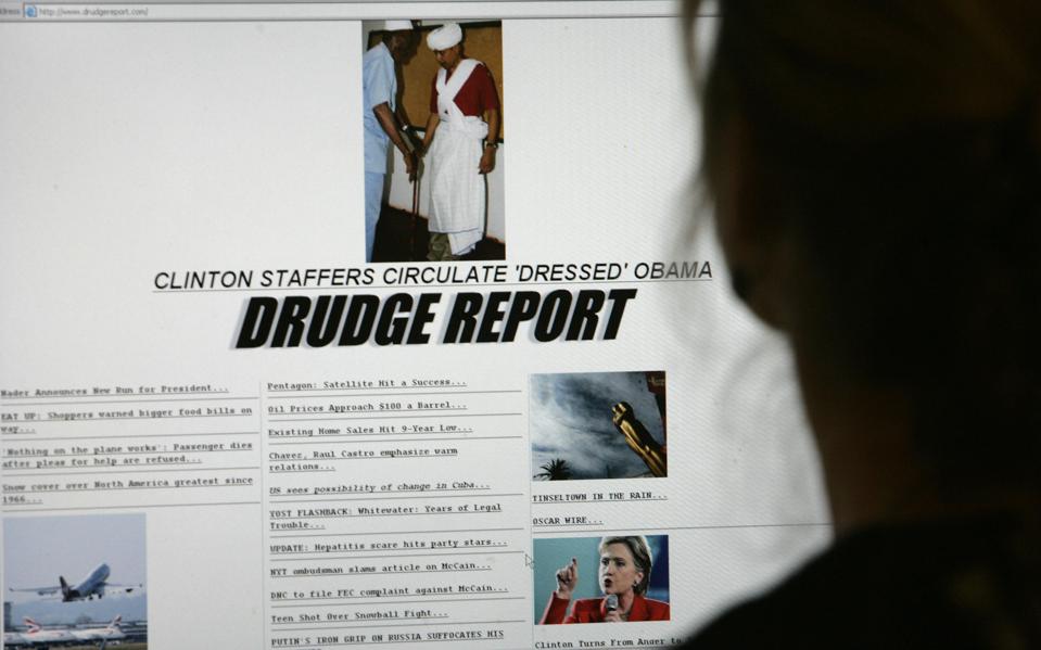 A woman looks at the Drudge Report website
