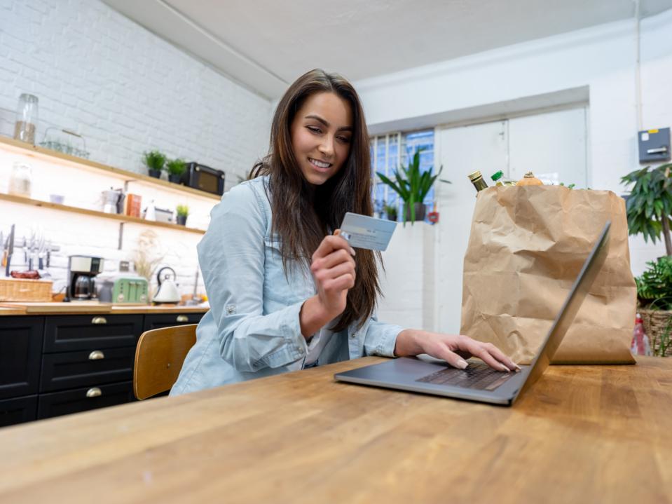 Woman grocery shopping online paying by credit card