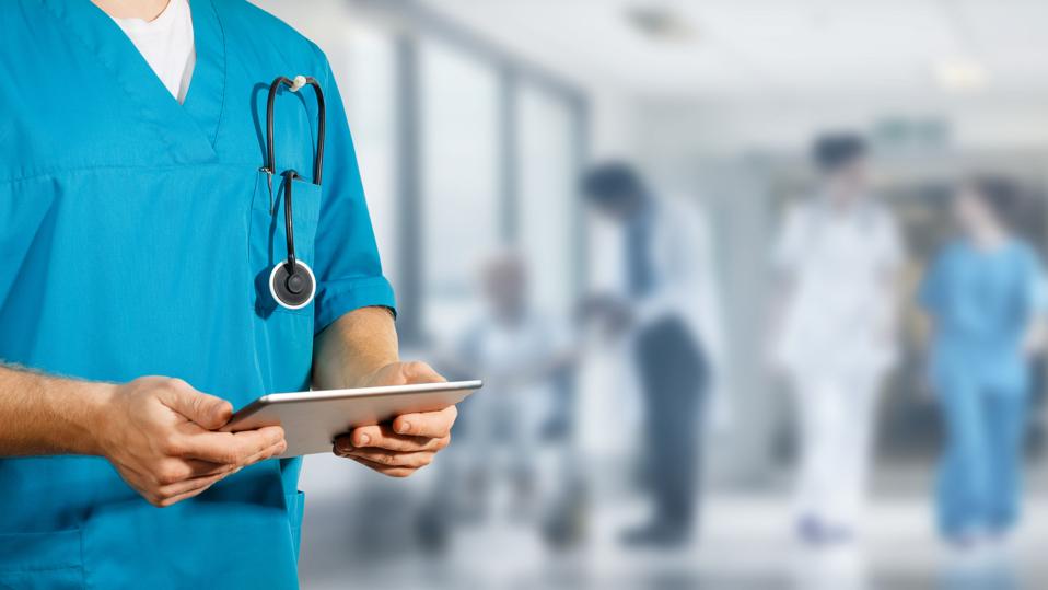 Concept of global medicine and healthcare. Doctor holds digital tablet. Diagnostics and modern technology