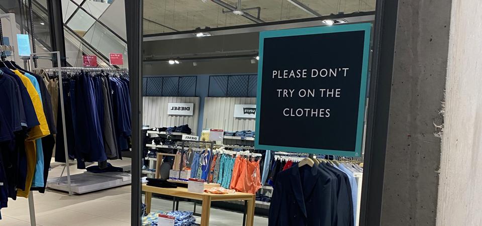 Mirror at John Lewis Department store in Leeds with sign requesting customers do not try on clothes, August 2020