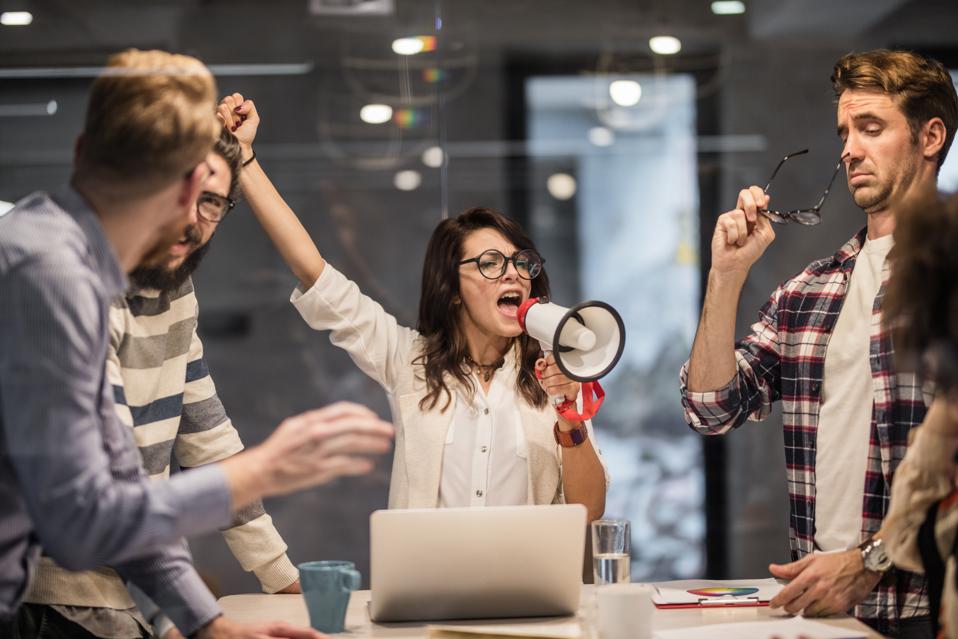 Noisy workplace being led with megaphone.
