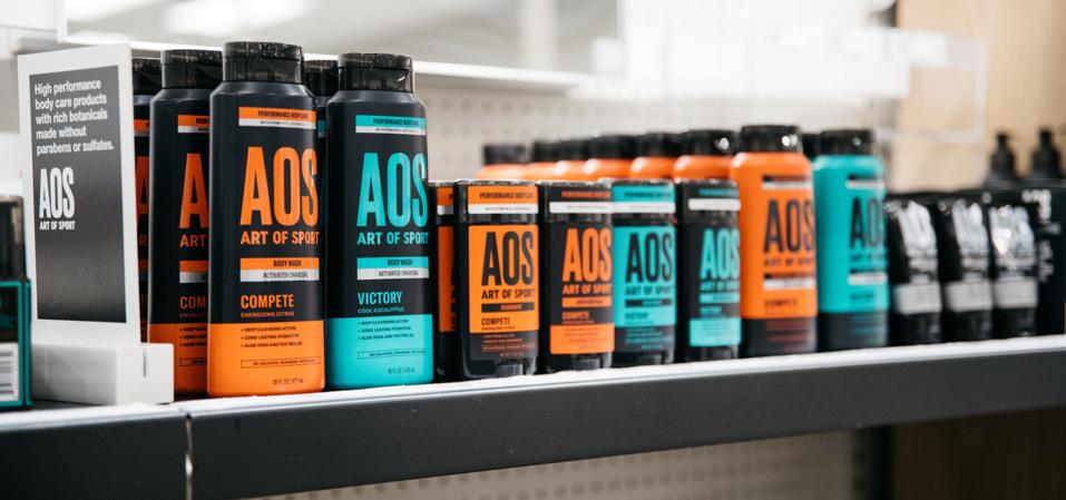 A shelf at a Target store showing Art of Sport body wash ans skincare products.