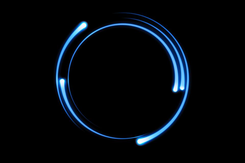Blue fire comet light flying in circle. Shining lights in motion with particles on black sky. Ring of fire, abstract background