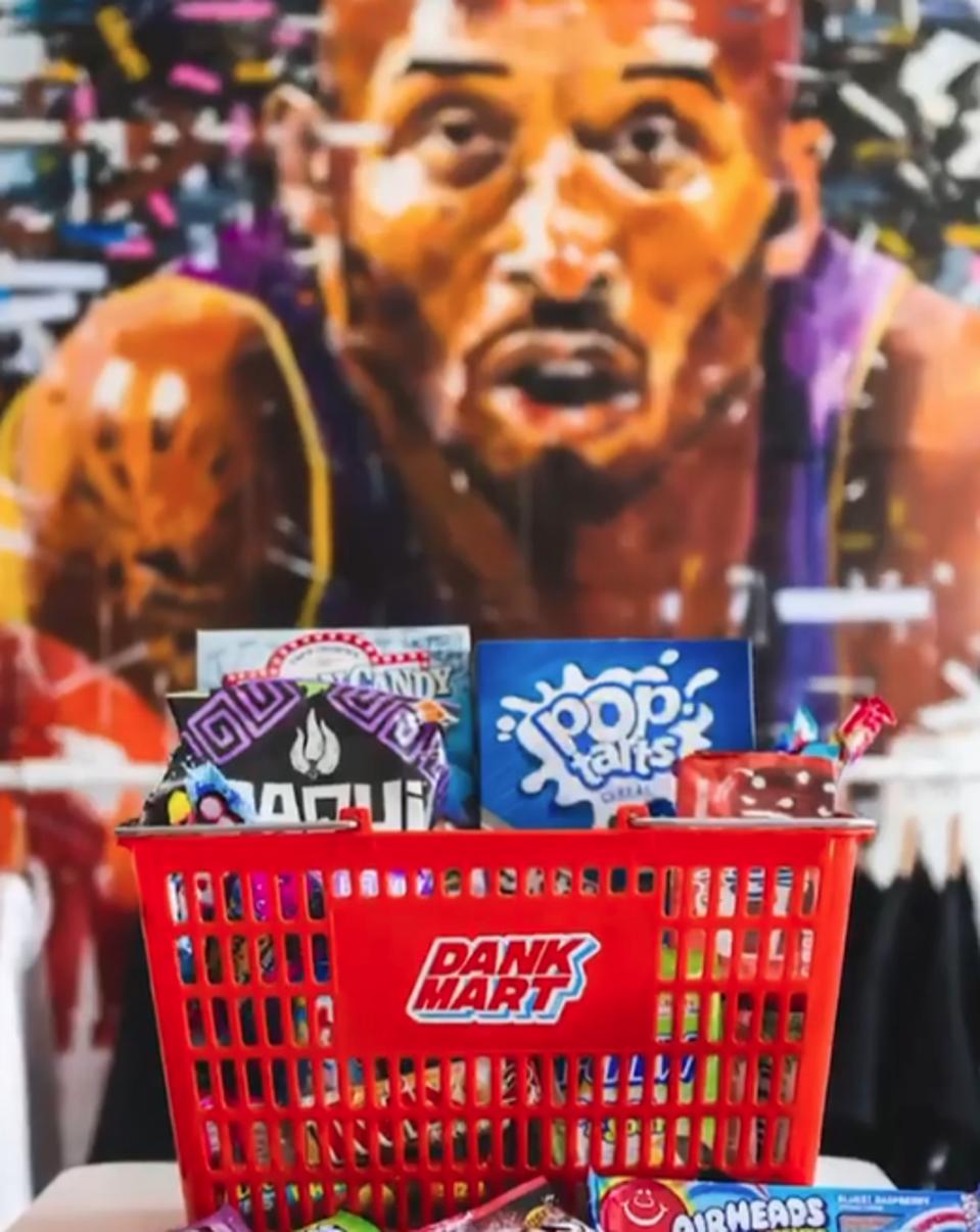 A selection of snacks available at Dank Mart, pictured in front of a Kobe Bryant mural.