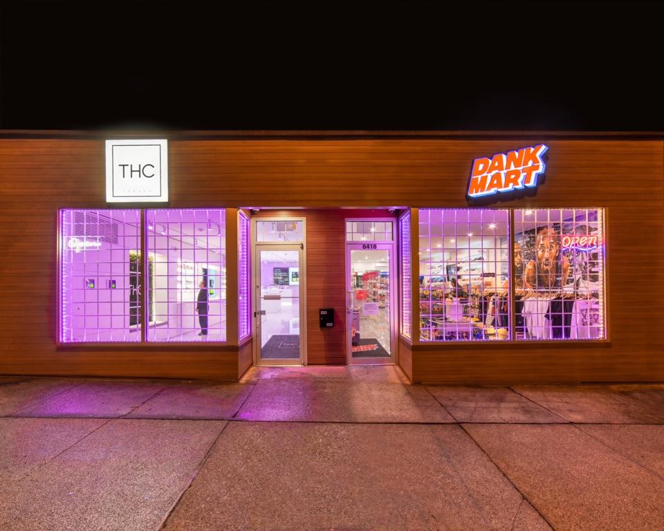 THC Canada and Dank Mart are seen from the outside at night time.